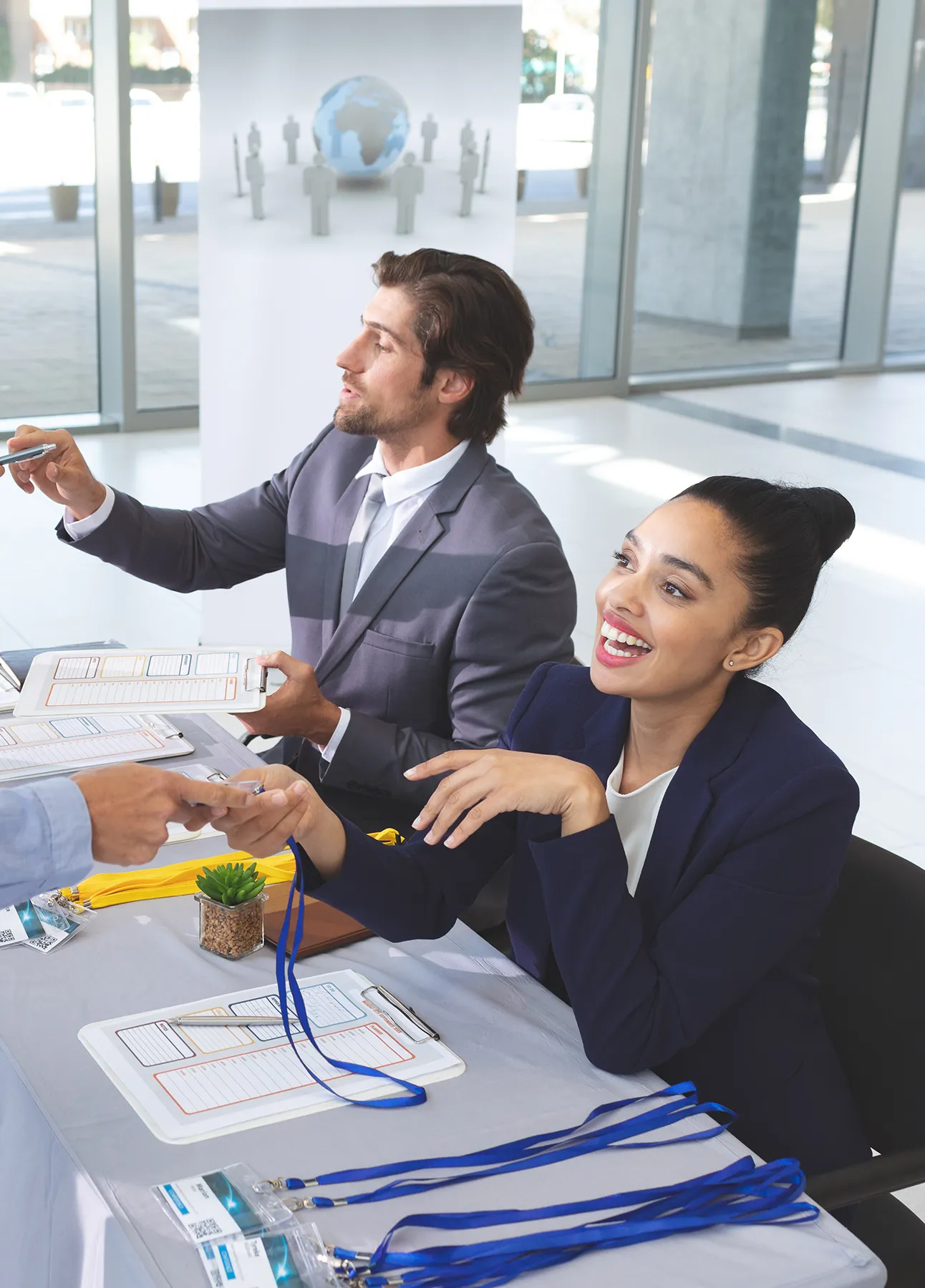 Side view of diverse business people checking in at conference registration table in office lobby