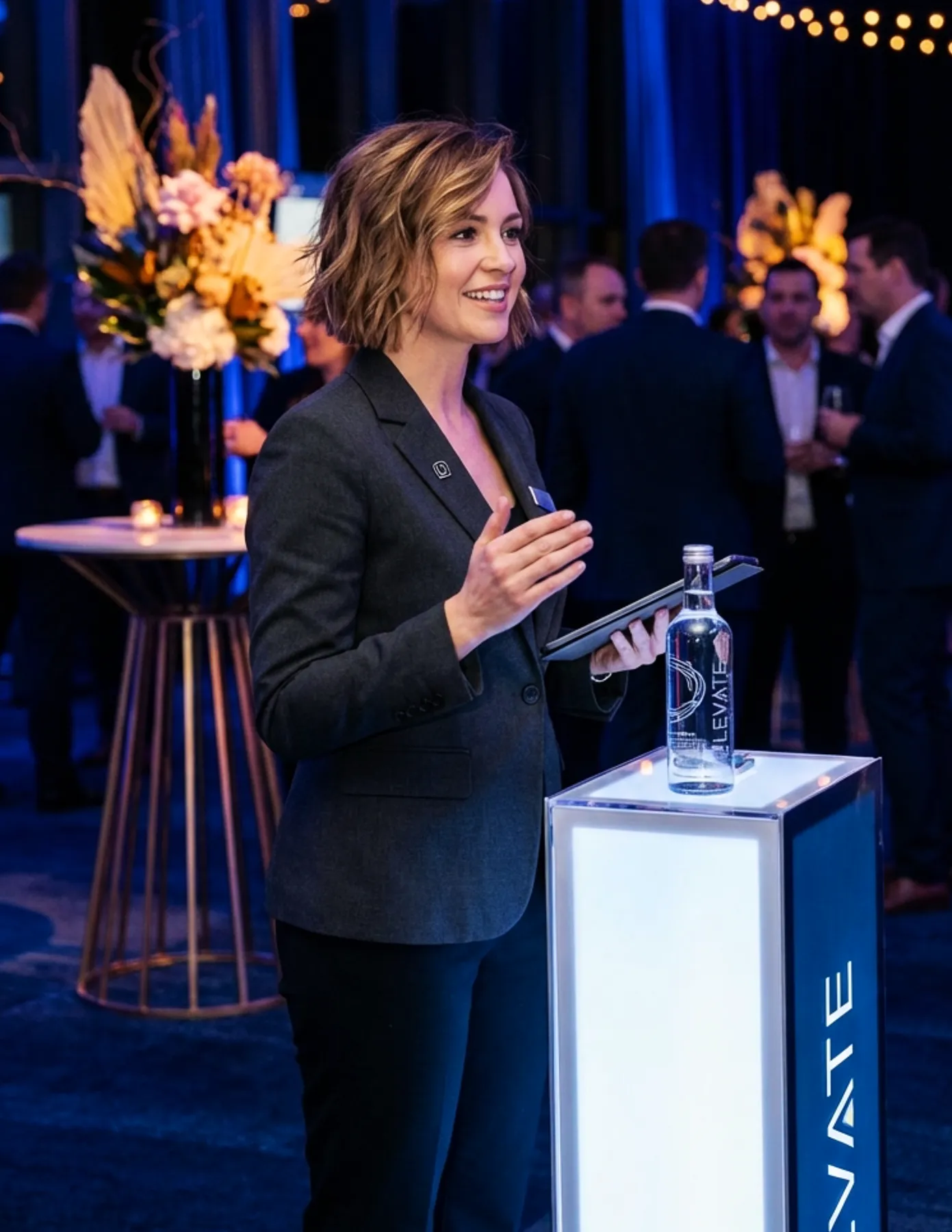 Professional event hostess welcoming guests at a corporate event