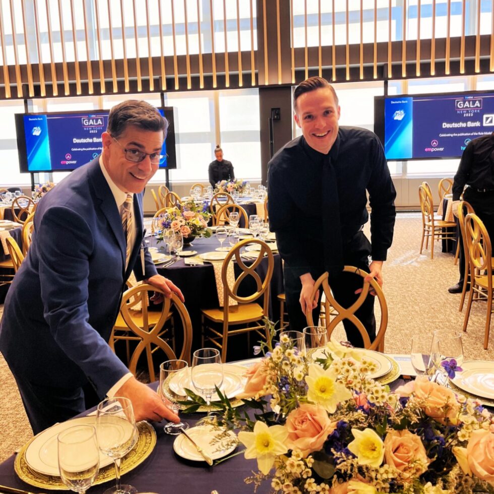 HMG+ event staff setting up an elegantly decorated gala dinner table at a prestigious corporate event in New York City