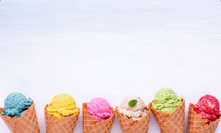 Six waffle cones each topped with a single scoop of brightly colored ice cream — blue, yellow, pink, beige, green, and red — lined up in a row along the bottom of a light blue background.